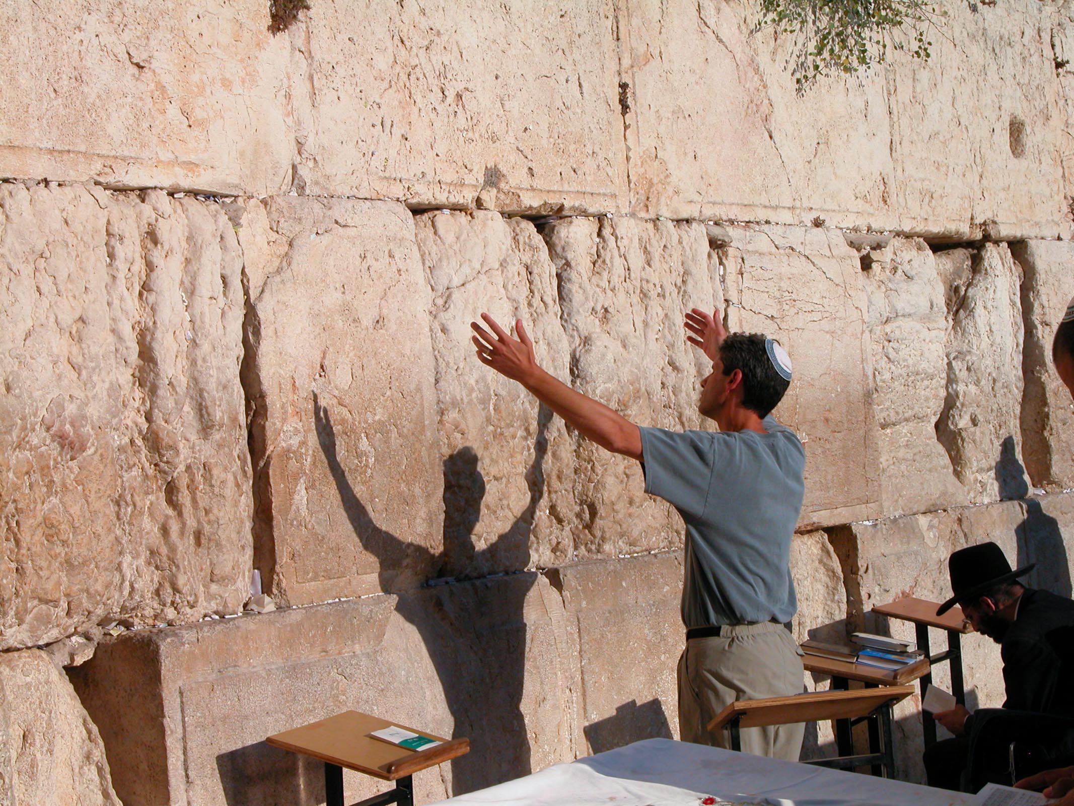 Man with arms upraised at Western Wall. Courtesy of the [Pictorial Library of Bible Lands](https://www.bibleplaces.com)